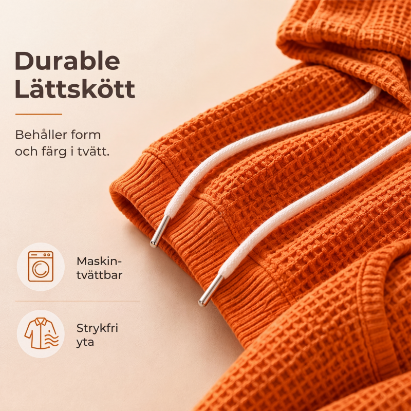 Damernas vaffelstickade luvtröja med lös passform och fickor