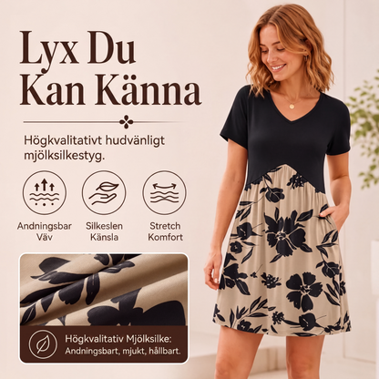 Damklänning med V-ringning och korta ärmar, längd upp till mitten av vaden
